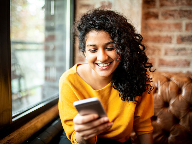 Woman interacting with her mobile device